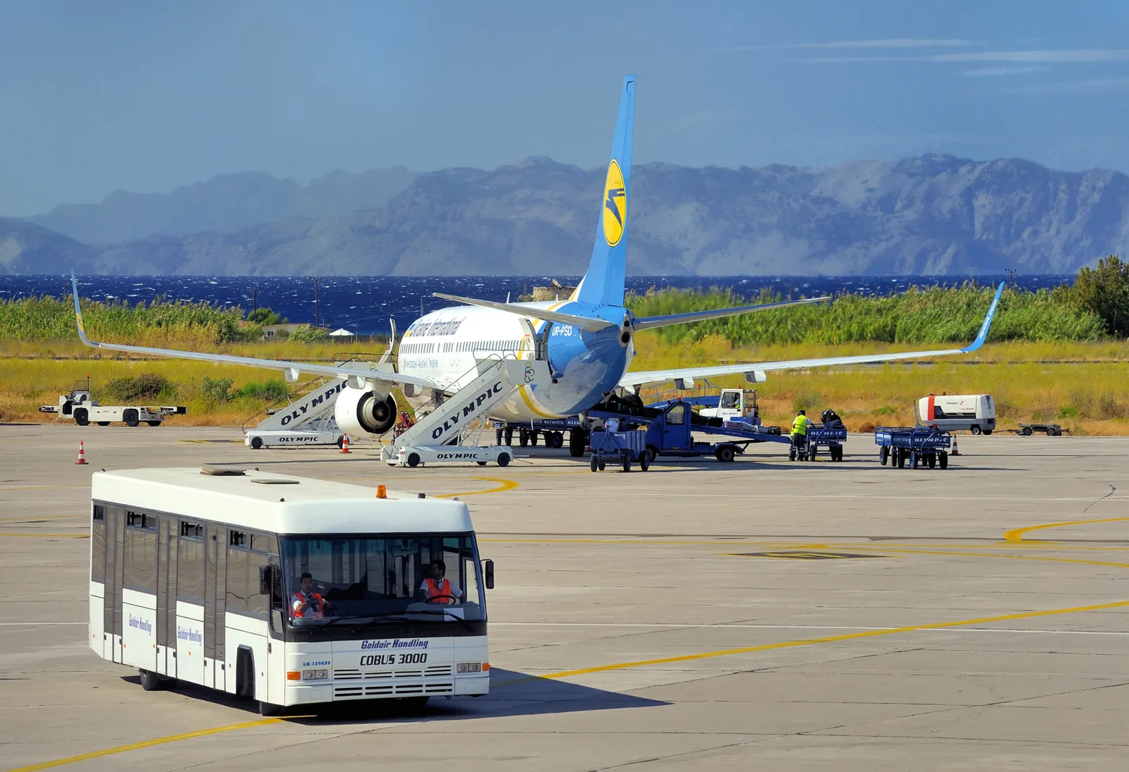 A passenger jet and apron bus at Rhodes Diagoras International Airport