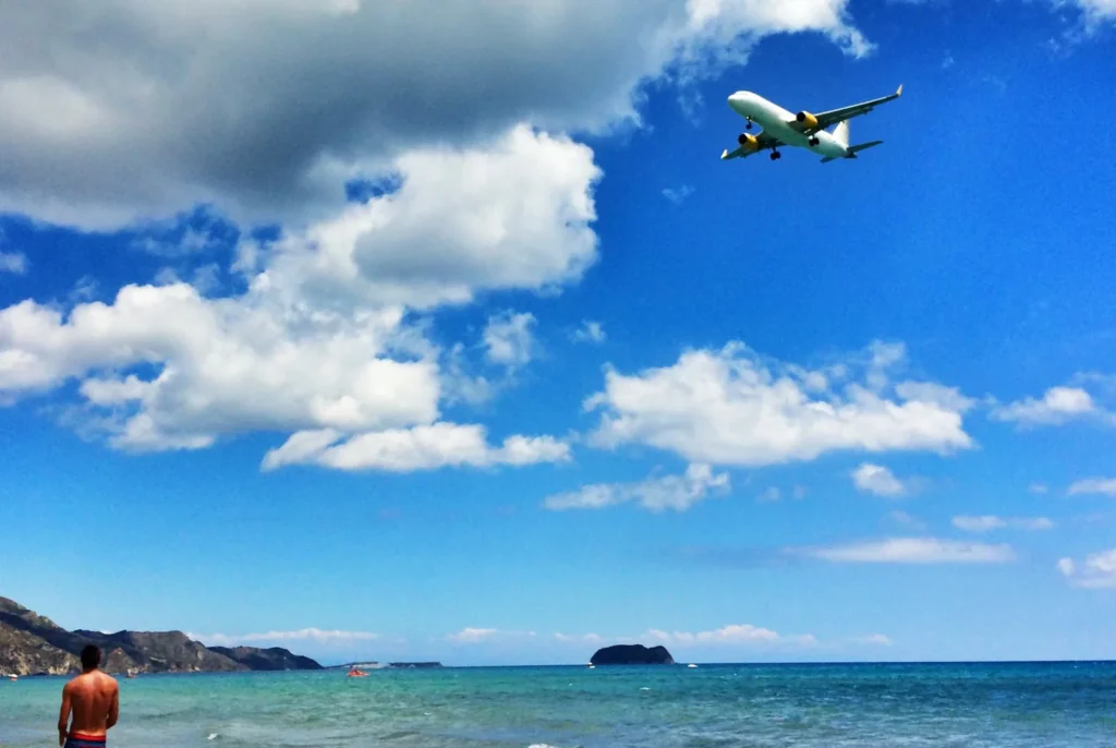 A passenger jet on final approach over the sea and Kalamaki beach to Zakynthos Airport